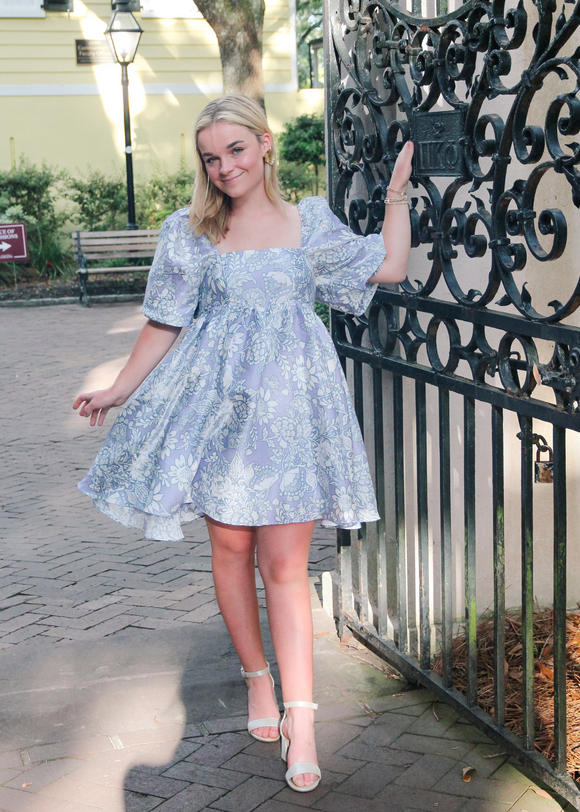 Calling all girly girls and Bridgerton fans, this is the perfect dress for you! Large white floral print over a gorgeous periwinkle color that has a lot been of sheen to make sure you shine bright like the seasons first diamond. This baby doll dress has a square neckline in the front and back and oversized puffy elastic sleeves.