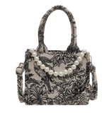 Rock this jungle mini bag with pearl details on your next trip! Or class up your outfit and show it off to the girls. This designer inspired tote is sure to please with its own individuality that will spic up your wardrobe. Whats more classy and sassy than pears paired with jungle print?  Small size canvas bag with jungle theme print.  Canvas Material Pearl Charm Detail  Structured Top Handle & Removable Shoulder Strap Small Size 